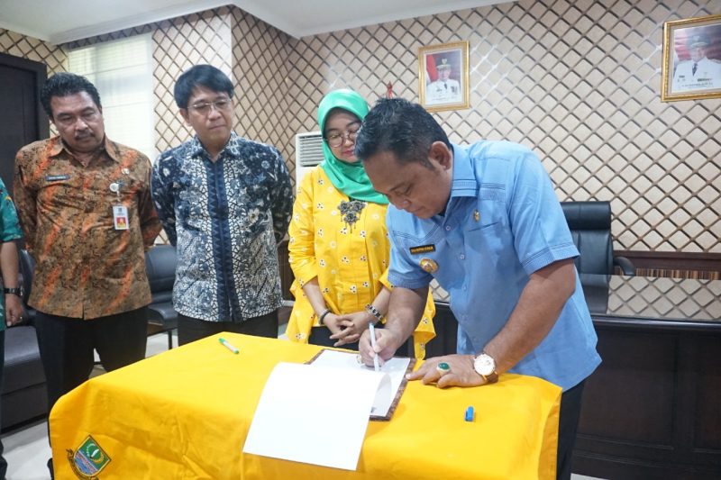 Foto: Bupati Bekasi, Eka Supria Atmaja melakukan penandatanganan MoU Program Layan Antar Dokumen Adminduk antara Pemkab Bekasi dengan PT. Pos Indonesia