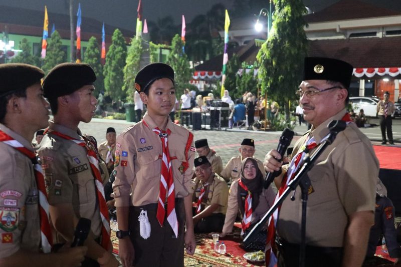 Wakil Wali Kota Bekasi, Abdul Harris Bobihoe, berdialog dengan anggota pramuka saat memimpin upacara penyalaan api unggun dalam rangka memperingati Hari Pramuka ke-64 di Plaza Pemkot Bekasi, Kamis malam (14/8/2025).