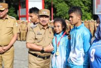 Wakil Walikota Bekasi Harris Bobihoe memberikan apresiasi kepada atlet NPCI Kota Bekasi peraih prestasi pada Kejuaraan Daerah Tingkat Provinsi Jawa Barat Tahun 2025, usai memimpin apel pagi ASN di lingkungan Pemerintah Kota Bekasi, Senin (15/12/2025).