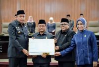 Wali Kota Bekasi Tri Adhianto bersama Ketua DPRD Kota Bekasi Sardi Efendi, Wakil Ketua DPRD Nuryadi Darmawan, dan Puspa Yani menunjukkan dokumen kesepakatan Rancangan Peraturan Daerah (Raperda) tentang Penyertaan Modal BUMD usai rapat paripurna di Gedung DPRD Kota Bekasi, Kamis (5/3/2026). Kesepakatan tersebut menjadi langkah memperkuat peran BUMD dalam mendukung pembangunan daerah dan meningkatkan Pendapatan Asli Daerah (PAD).