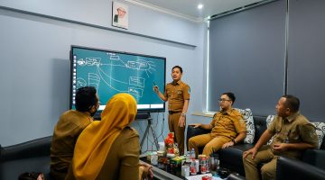 Sejumlah aparatur Pemerintah Kabupaten Bekasi mengikuti rapat koordinasi terkait penguatan layanan teknologi informasi di ruang kerja, dengan pemaparan materi menggunakan layar digital, Selasa (7/4/2026).